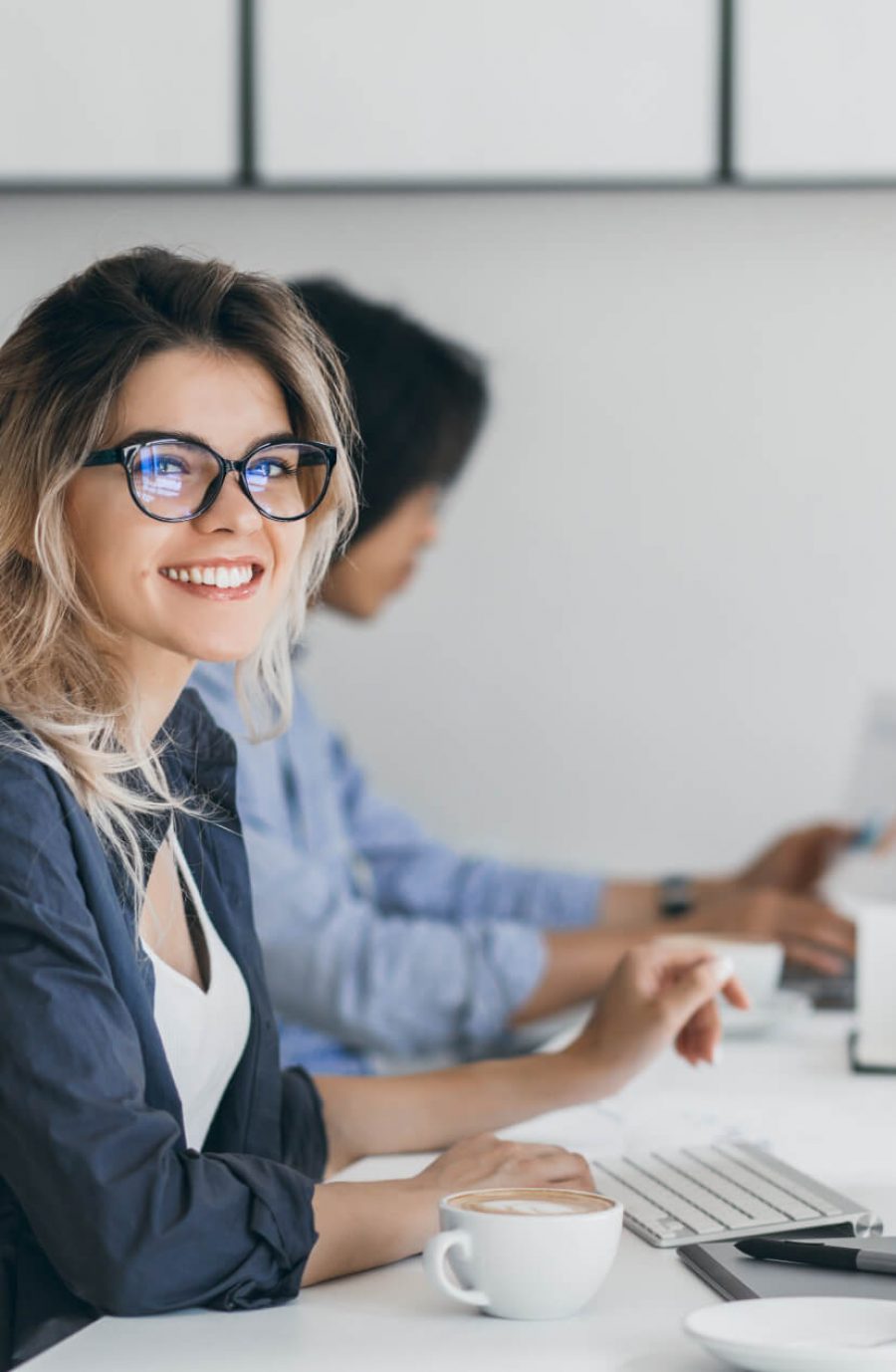 attractive-laughing-freelancer-woman-posing-with-cup-coffee-her-workplace-chinese-student-blue-shirt-works-with-document-campus-with-blonde-friend-glasses